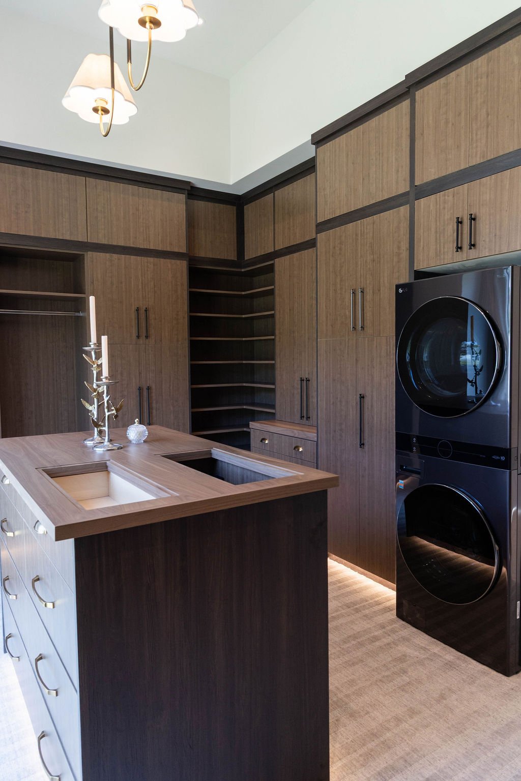 Custom walk-in closet with built-in cabinetry and integrated laundry in a custom home featured in the 2025 Utah Valley Parade of Homes
