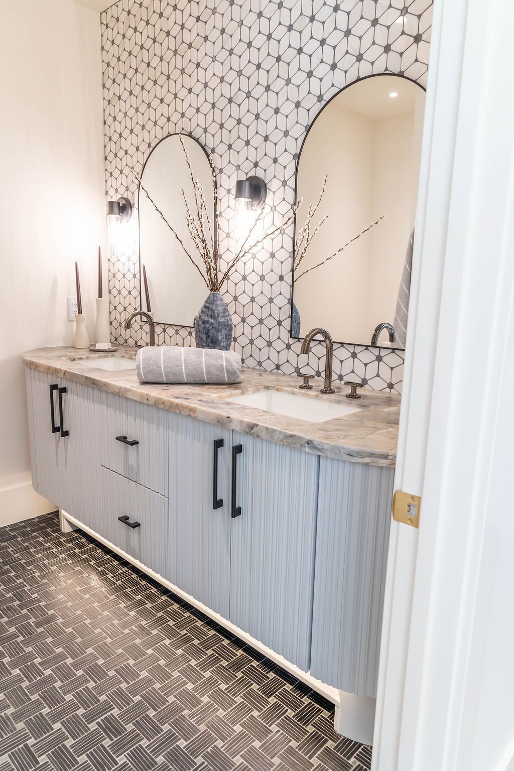Dual sink vanity with marble countertop and textured tile in custom home featured in the 2025 Utah Valley Parade of Homes by E Builders