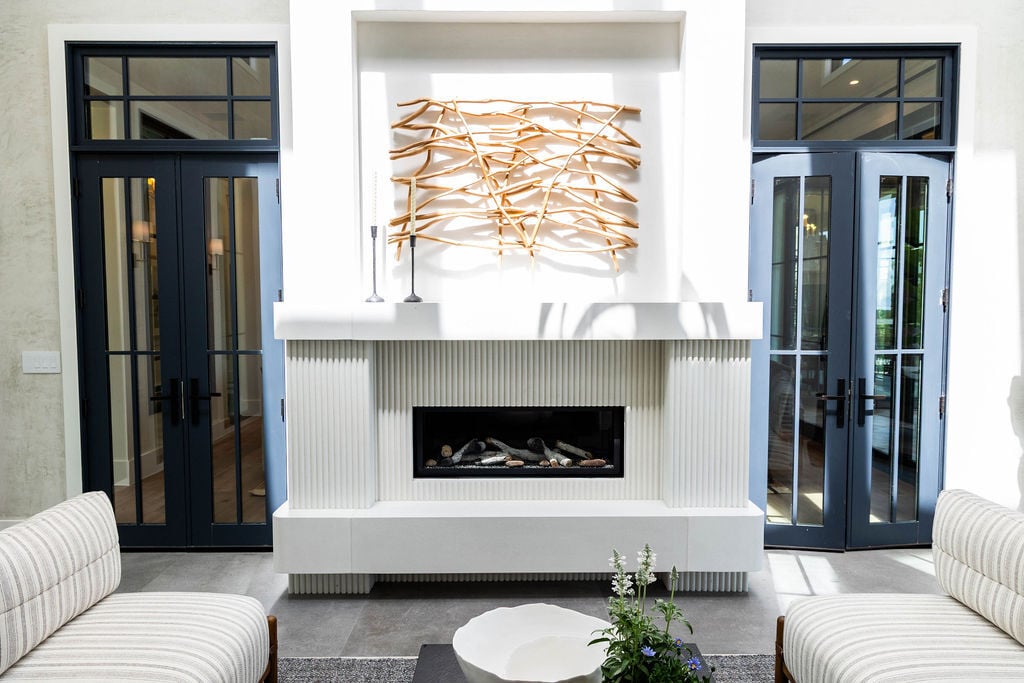 Elegant courtyard fireplace centerpiece in custom home by E Builders, 2025 Parade of Homes