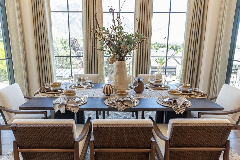 Formal dining setup with neutral tones and natural light in a Utah Valley Parade custom home