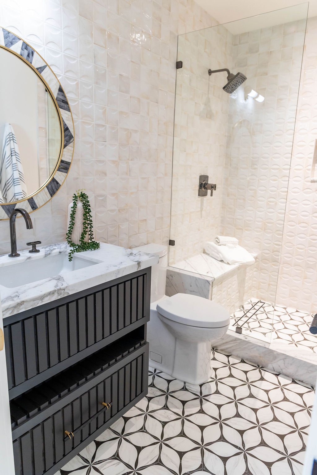 Full bathroom featuring black vanity, large mirror, and tile floor in a custom home featured in the 2025 Utah Valley Parade of Homes