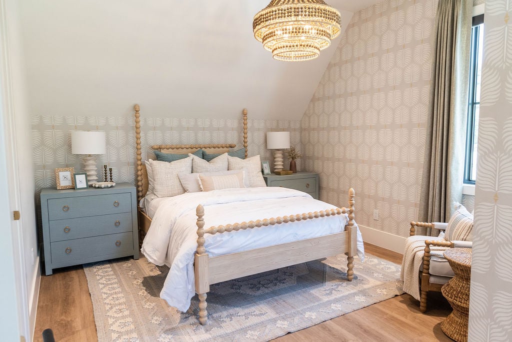 Inviting guest room with natural textures and layered bedding in a custom home featured in the 2025 Utah Valley Parade of Homes