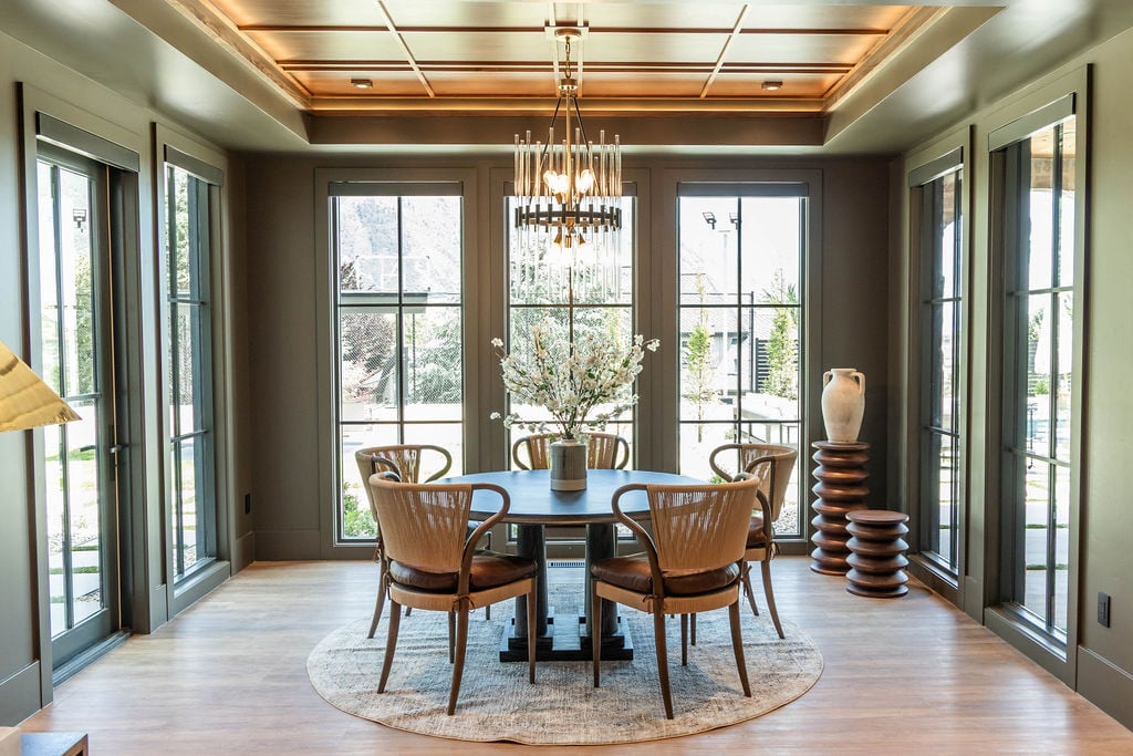 Light-filled breakfast nook framed by black-trimmed glass doors in a custom home featured in the 2025 Utah Valley Parade of Homes