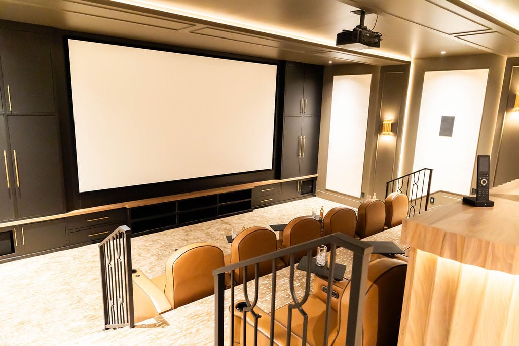 Luxury home theater with tiered leather seating in a custom home featured in the 2025 Utah Valley Parade of Homes