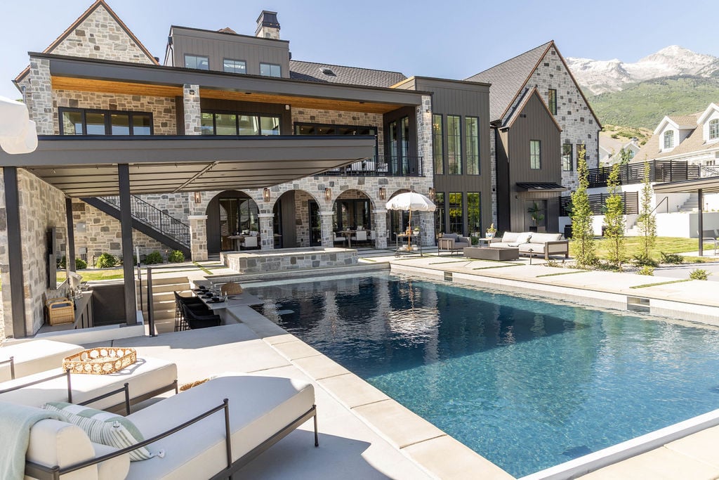Luxury pool area with covered cabana and spacious patio in a custom home featured in the 2025 Utah Valley Parade of Homes