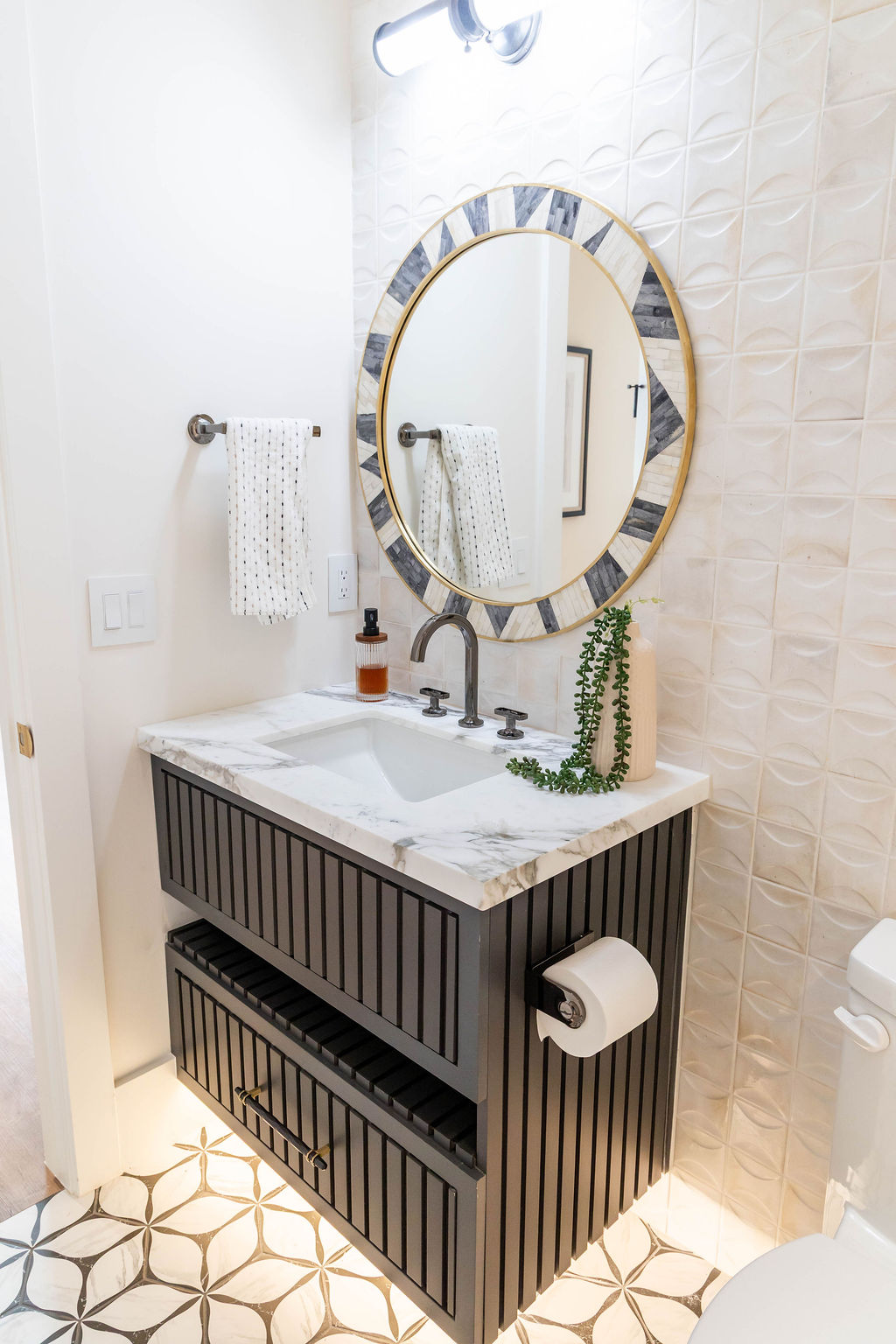 Modern bathroom vanity with black wood cabinet and marble countertop in a custom home featured in the 2025 Utah Valley Parade of Homes