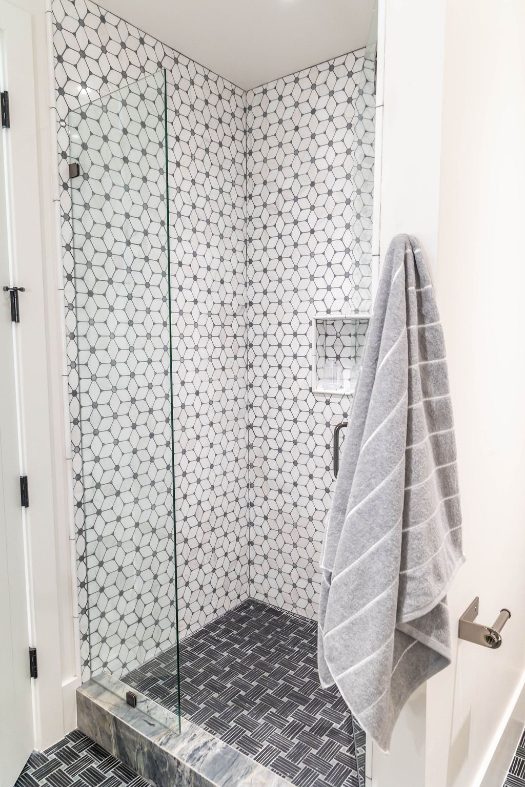 Modern geometric tile shower in custom home featured in the 2025 Utah Valley Parade of Homes by E Builders