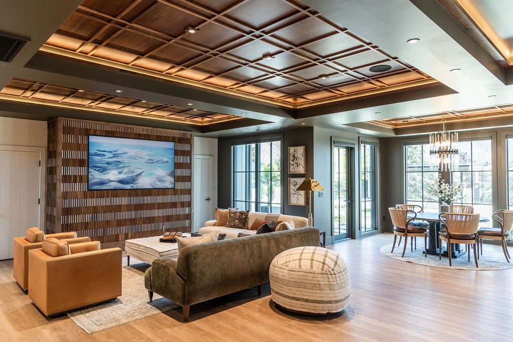 Open concept basement living area with wood-paneled ceiling and natural light in a custom home featured in the 2025 Utah Valley Parade of Homes