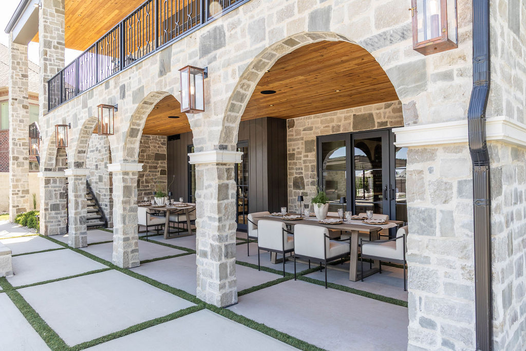 Stone arch patio dining area of a custom home patio featured in the 2025 Utah Valley Parade of Homes