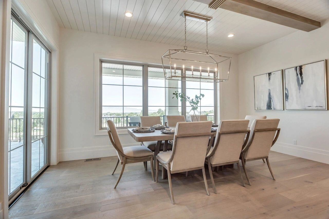 Bright and airy dining area with seating for eight in a custom home in Utah built by E Builders