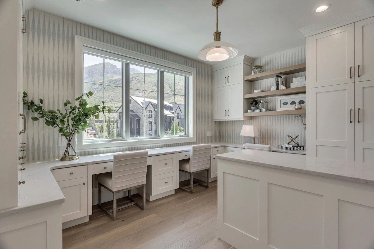 Craft room with built-in desks and mountain views in a custom home in Utah built by E Builders
