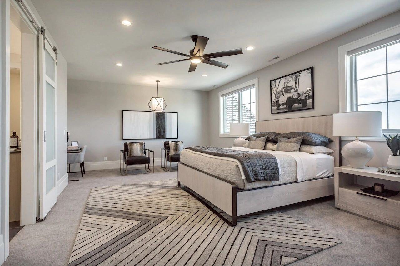 Guest suite with neutral palette and modern furnishings in a custom home in Utah built by E Builders