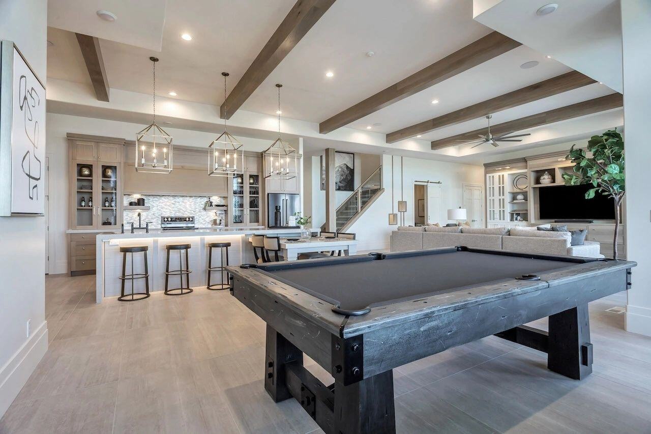 Open concept basement with game room and kitchen in a custom home in Utah built by E Builders
