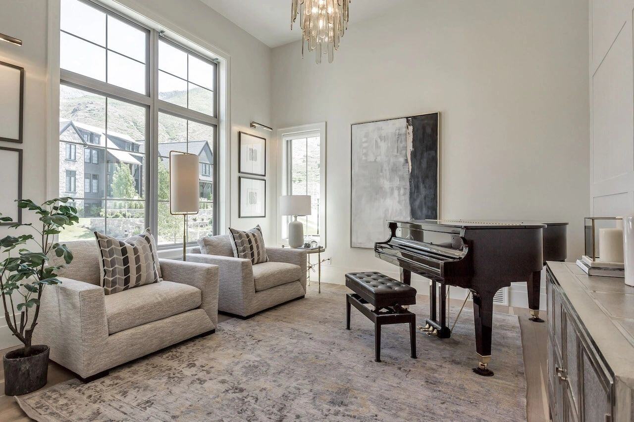 Sophisticated sitting area with piano and modern art in a custom home in Utah built by E Builders