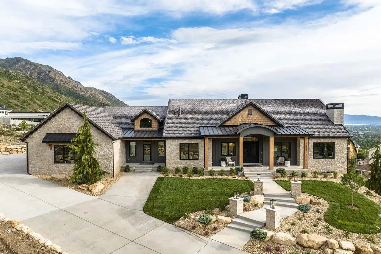 Elevated front landscape and stone façade in a custom home in Utah Valley by E Builders